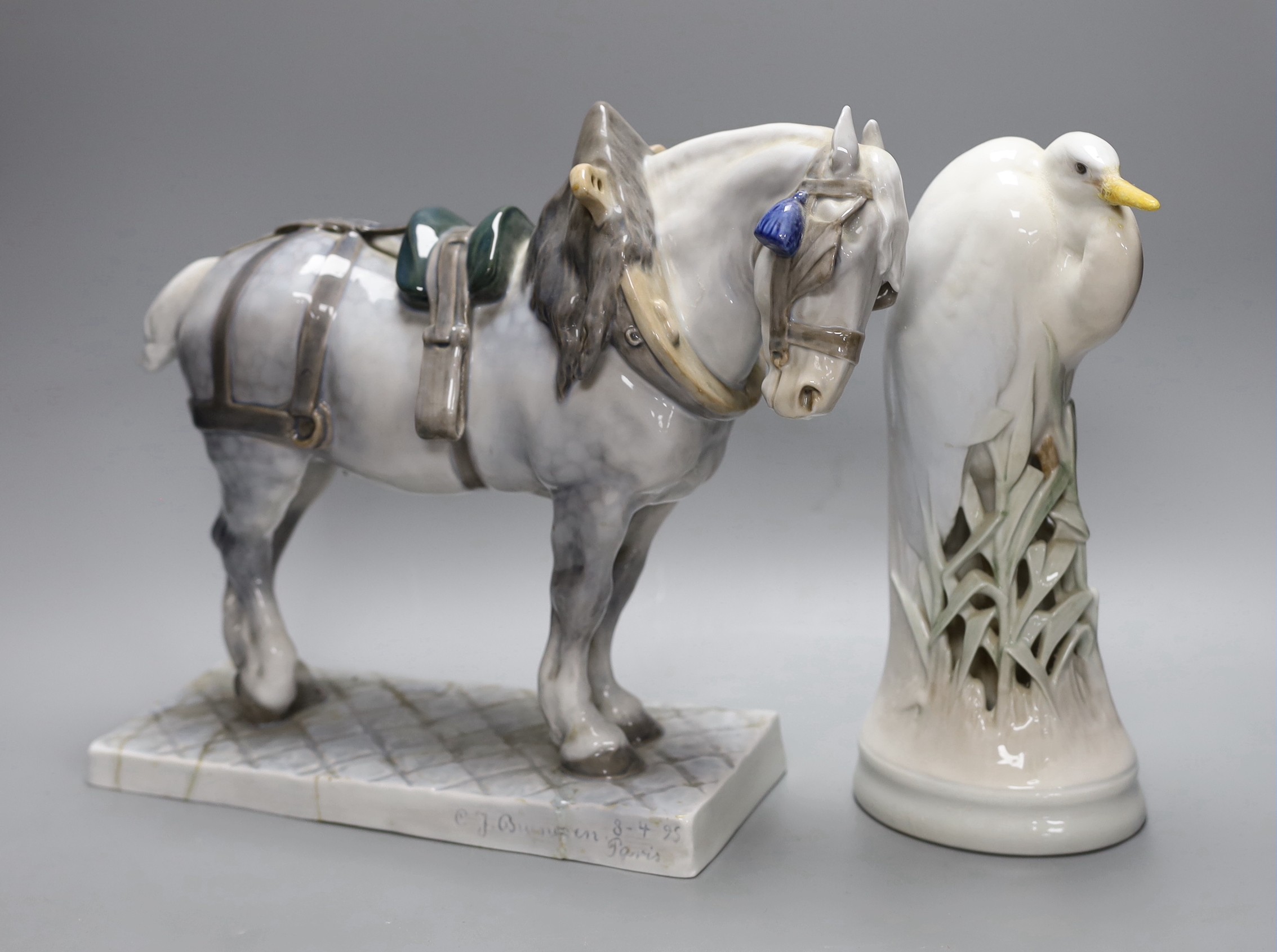 A Royal Copenhagen ceramic model of a shire horse, signed and dated and a similar crane, both restored